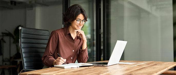 Women writing meeting minutes remotely