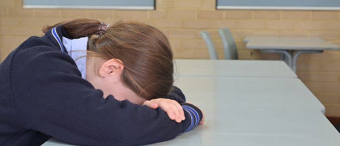 a child showing signs of sensory overload in a classroom 