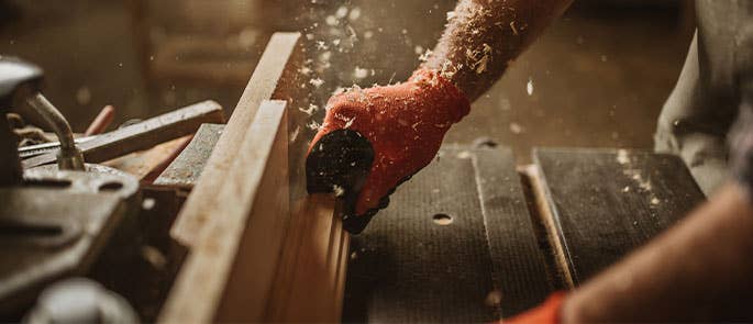 A carpenter using a wood tool