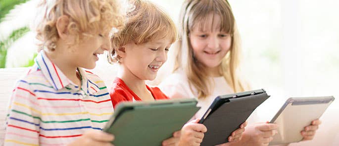 children enjoying screen time on tablets