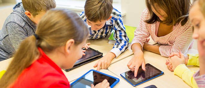 Children at school having screen time on tablets