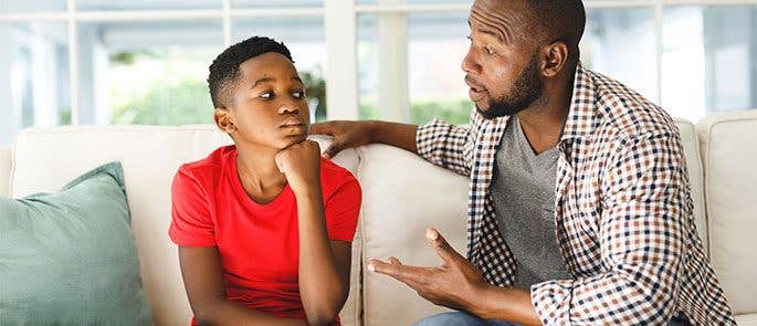 A parent speaking to his child about mental health