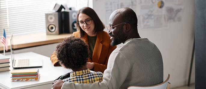 Parent and child having a meeting with school teacher