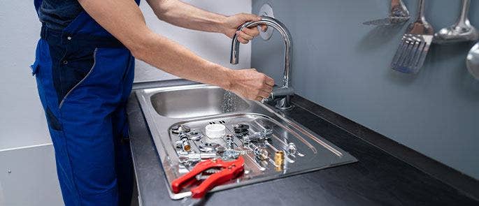 A plumber fixing a kitchen sink