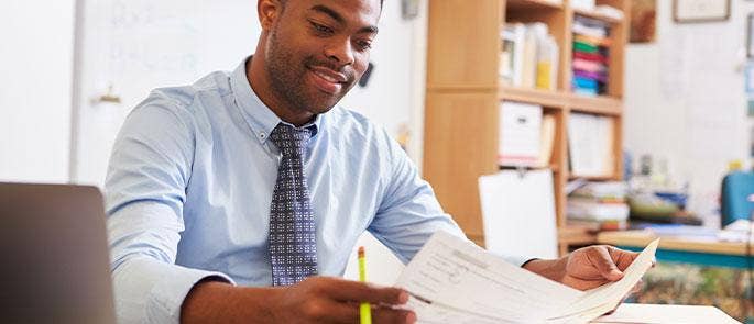 Teacher looking at his notes