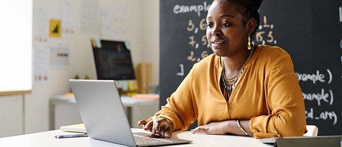 Teacher looking at a professional development plan on laptop