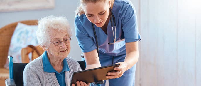 Health and social care worker helping a patient