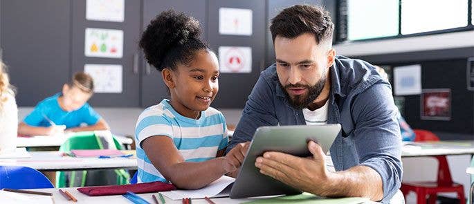 Teacher with pupil in the classroom