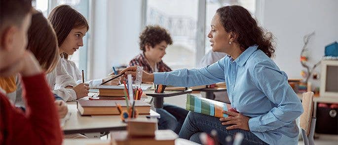 Teacher helping students in the classroom