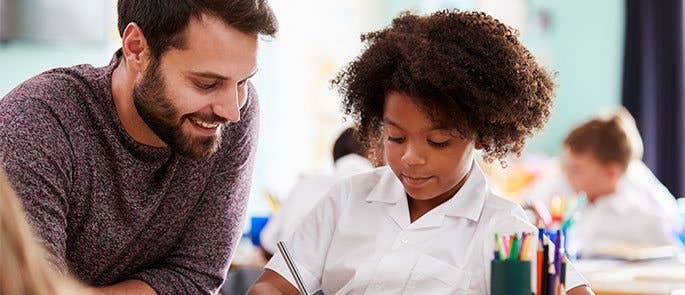 Teacher supporting pupil in the classroom