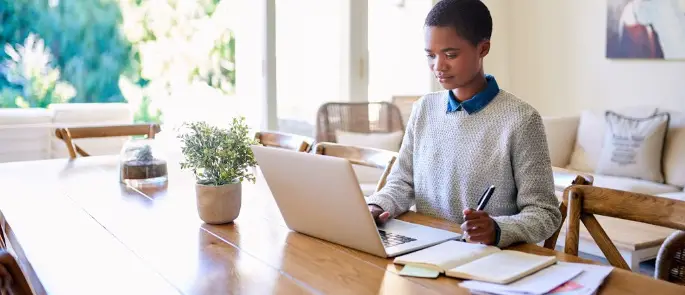 An employee taking meeting minutes remotely