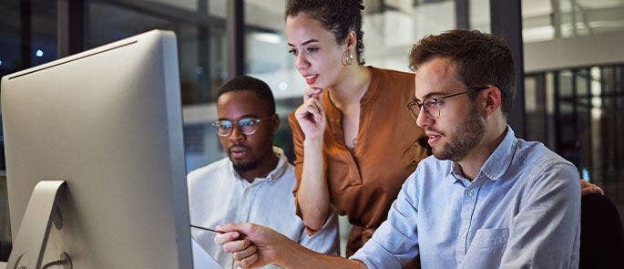 Employees looking at laptop