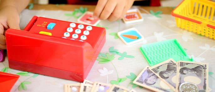 Money and till used to teach children financial literacy