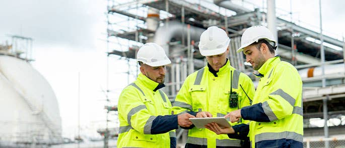 Site manager on site discussing with colleagues