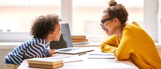 childcare professional talking to a child