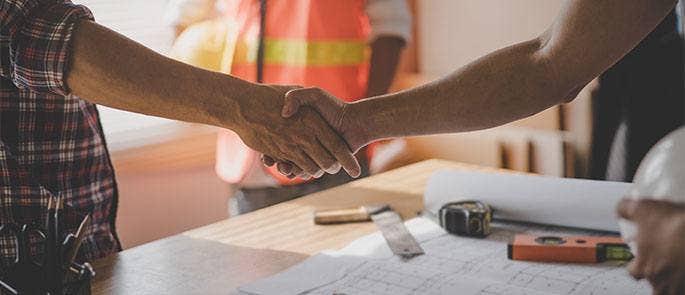 Construction workers shaking hands