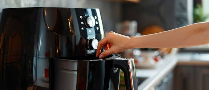 Consumer beginning to clean an air fryer