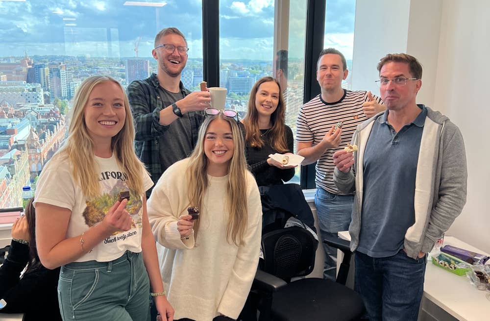 Image of a team of people smiling in an office